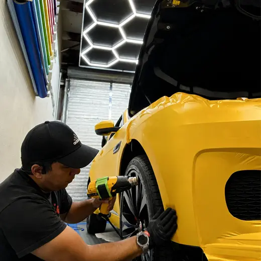 Technician installing vinyl film